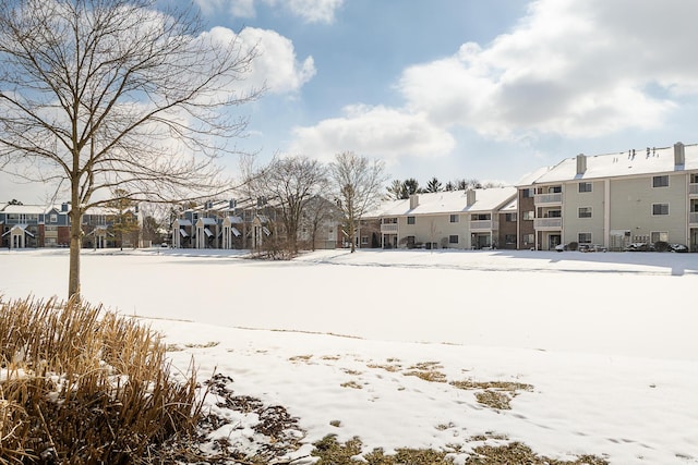 yard layered in snow with a residential view