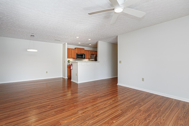 unfurnished living room featuring dark wood finished floors, recessed lighting, a ceiling fan, a textured ceiling, and baseboards