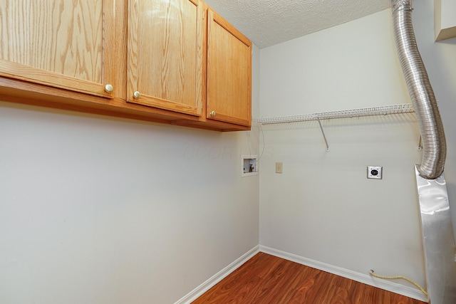 laundry room featuring hookup for a washing machine, baseboards, cabinet space, dark wood finished floors, and electric dryer hookup