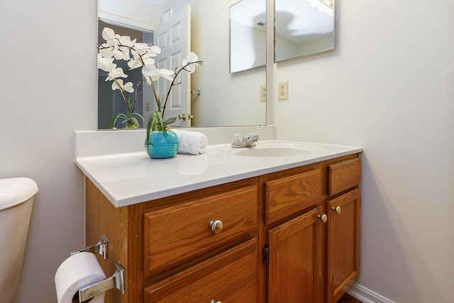 half bathroom with toilet and vanity