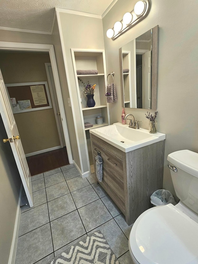 half bathroom with vanity, crown molding, tile patterned floors, and a textured ceiling