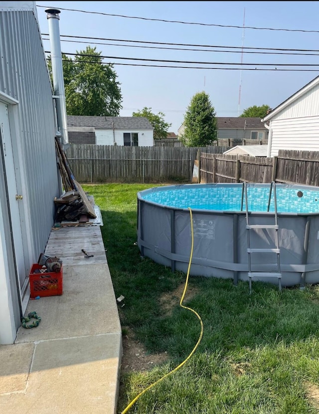 view of yard with a fenced in pool and fence