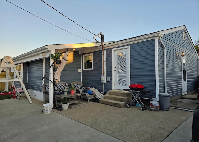 rear view of property featuring entry steps and a patio