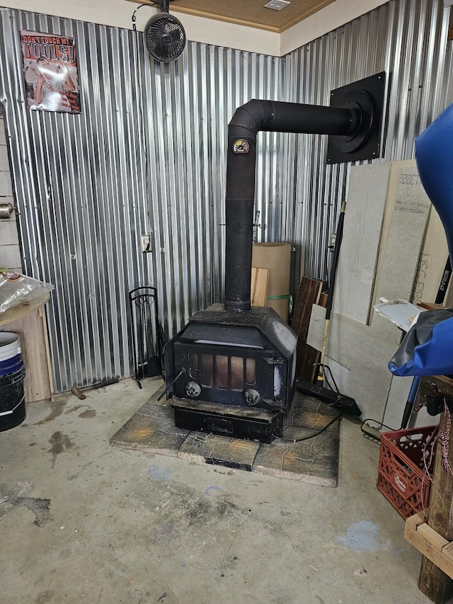 interior details with concrete floors and a wood stove