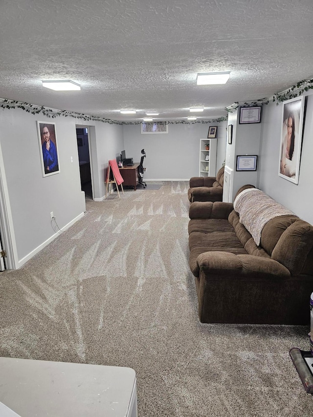 carpeted living room featuring baseboards and a textured ceiling