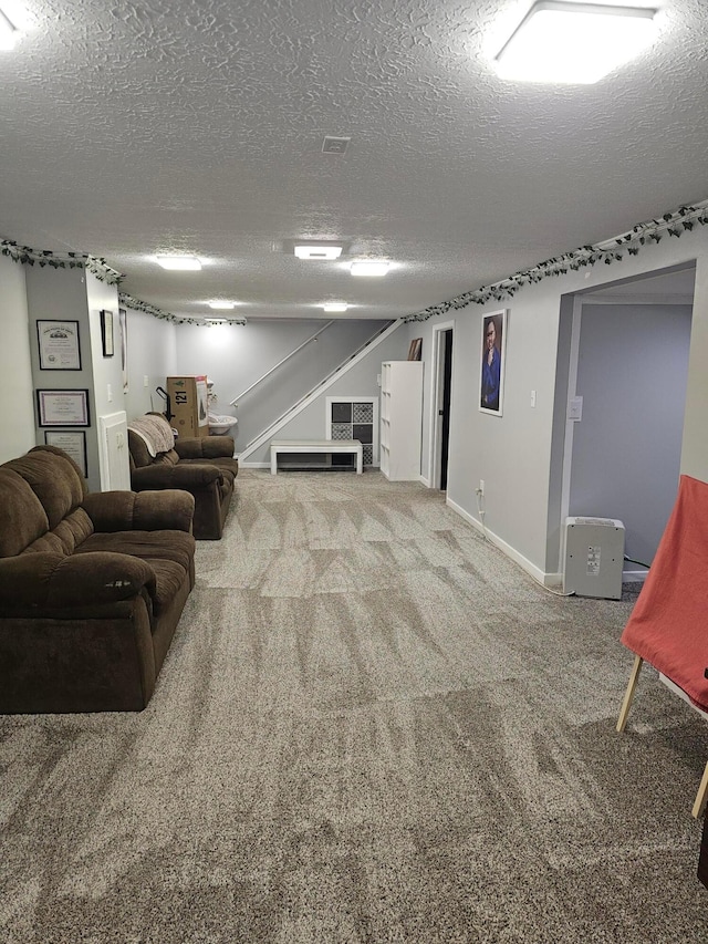 living area with stairs, carpet flooring, baseboards, and a textured ceiling