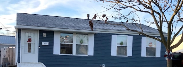 view of front of house featuring roof with shingles