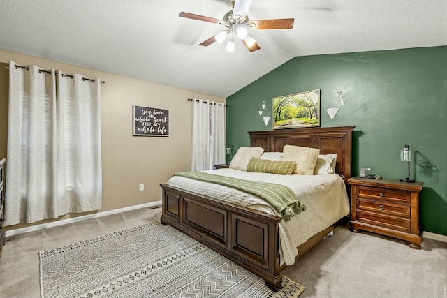 bedroom featuring baseboards, vaulted ceiling, a ceiling fan, and light colored carpet