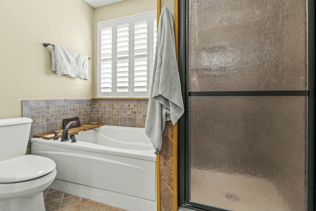 full bathroom with toilet, a stall shower, a bath, and tile patterned floors