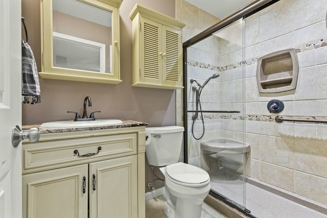 full bathroom featuring toilet, a shower stall, and vanity