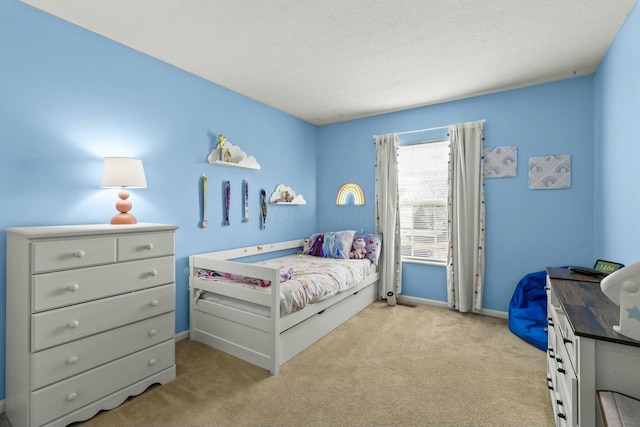 bedroom featuring light colored carpet, a textured ceiling, and baseboards