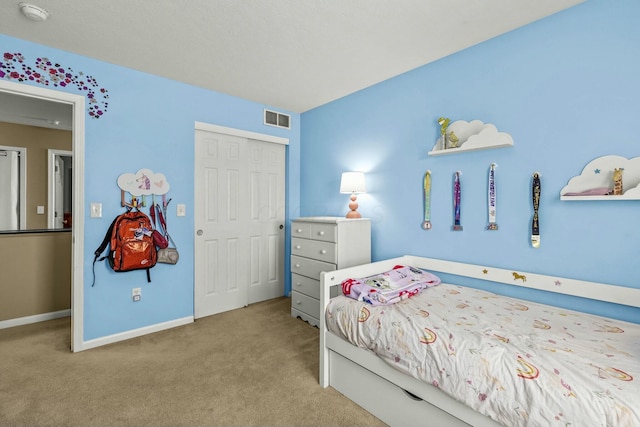 bedroom featuring light carpet, baseboards, visible vents, and a closet