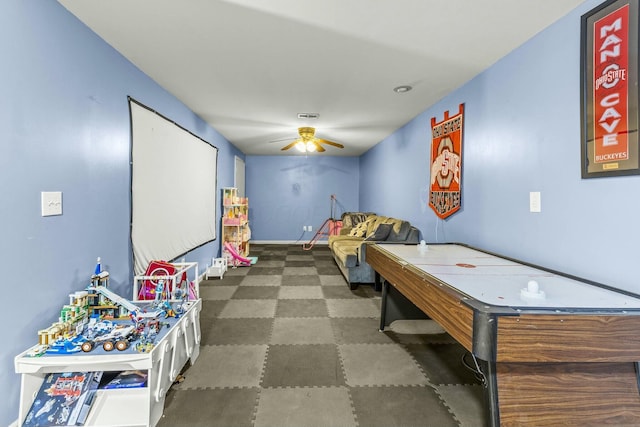 playroom featuring dark floors, visible vents, ceiling fan, and baseboards