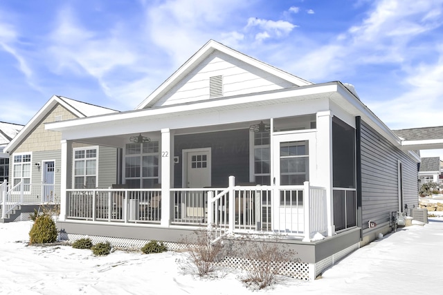 snow covered property featuring a porch