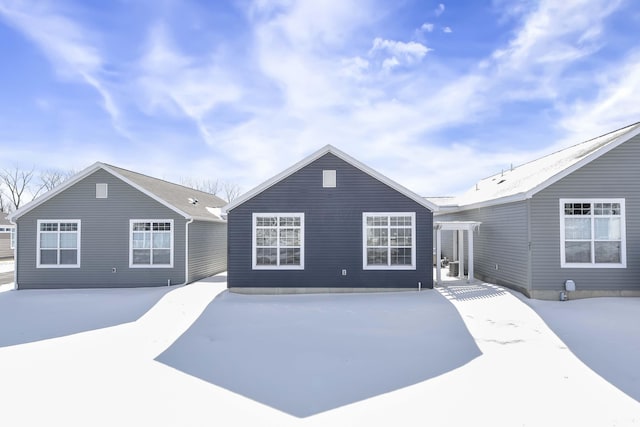 view of snow covered rear of property