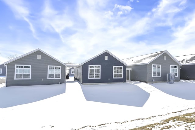 view of snow covered back of property