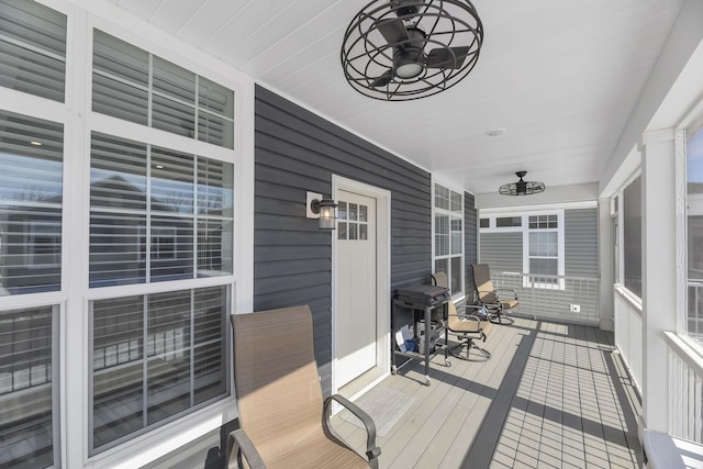 wooden terrace with a porch and a ceiling fan