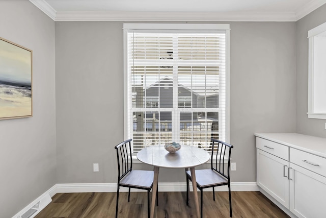 dining area with baseboards, ornamental molding, dark wood finished floors, and a healthy amount of sunlight