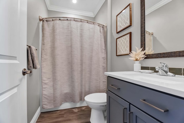 bathroom featuring toilet, a shower with shower curtain, wood finished floors, vanity, and ornamental molding