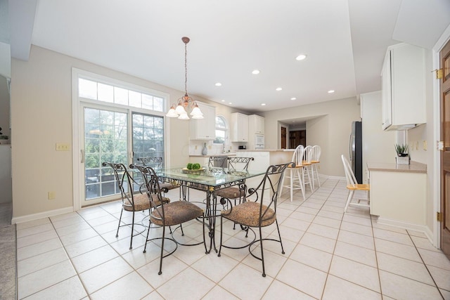 dining area featuring light tile patterned floors, a notable chandelier, recessed lighting, and baseboards