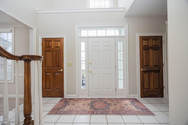 entrance foyer with light tile patterned floors and baseboards