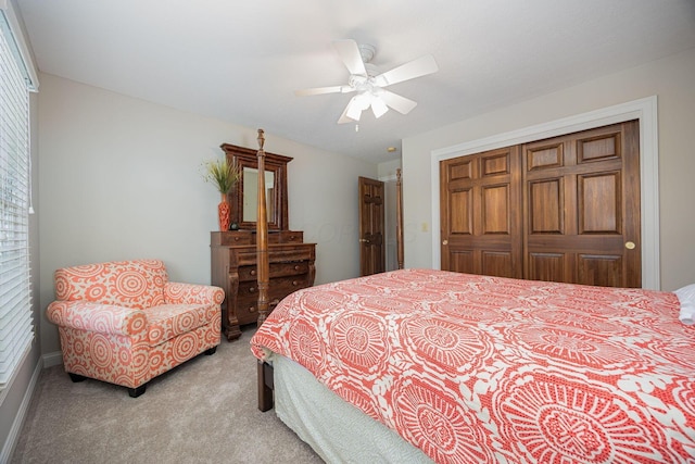 bedroom featuring ceiling fan, a closet, and light carpet