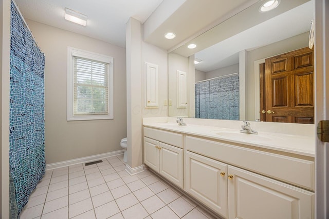 bathroom with tile patterned floors, visible vents, toilet, and a sink