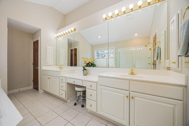 full bath with vanity, baseboards, tile patterned flooring, vaulted ceiling, and a shower stall
