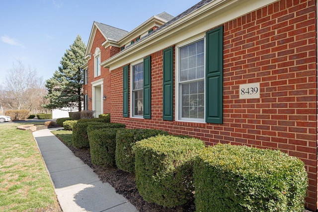 view of property exterior with brick siding