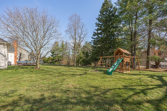 view of yard featuring a playground and a trampoline