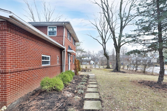 view of property exterior featuring brick siding