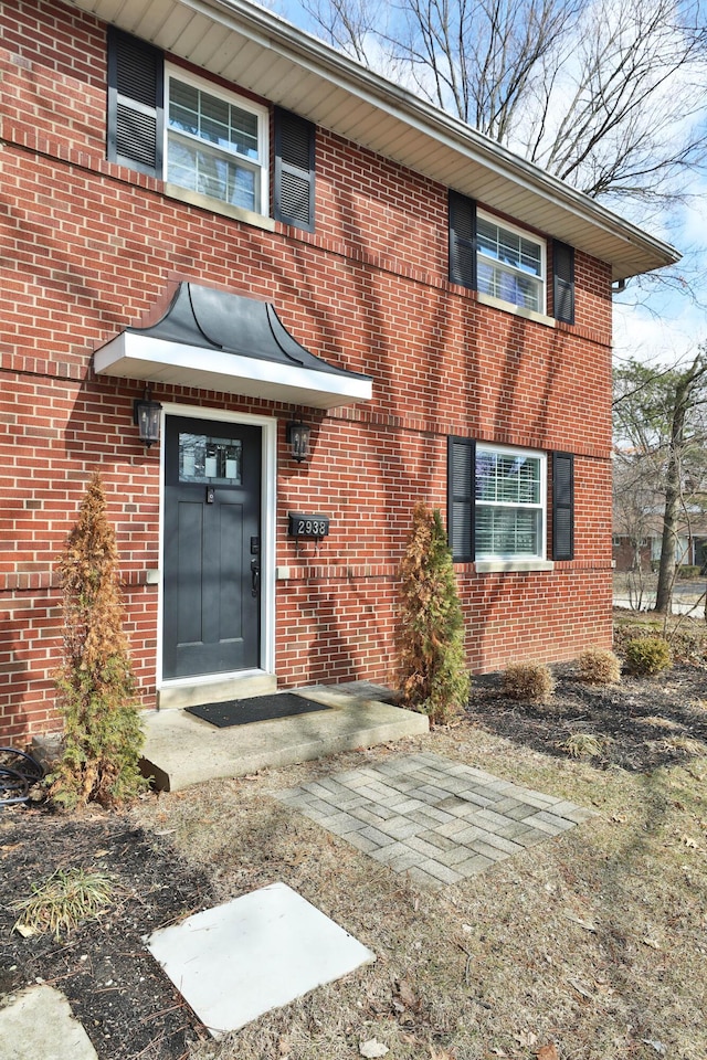 property entrance with brick siding