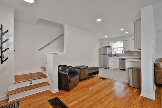 interior space with stairway, recessed lighting, visible vents, and light wood-style floors