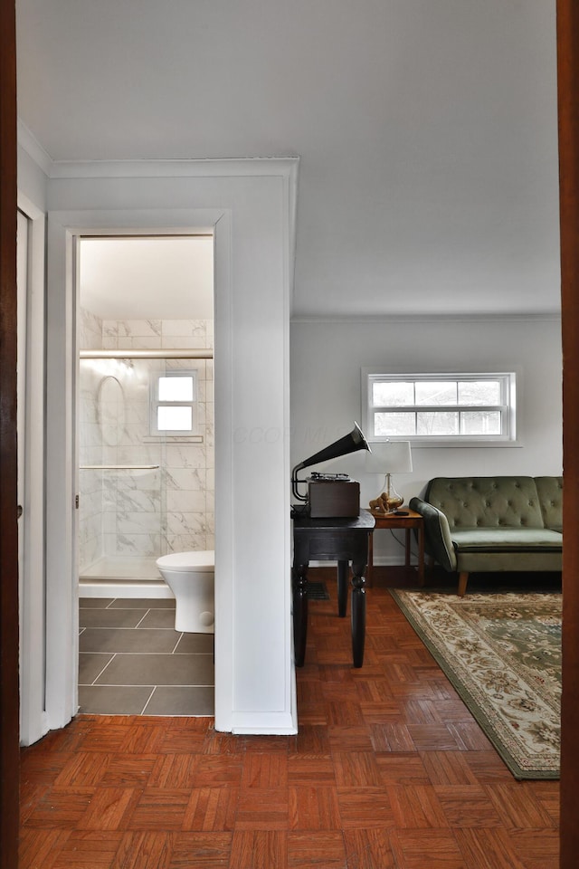 bathroom featuring ornamental molding, a stall shower, and a wealth of natural light