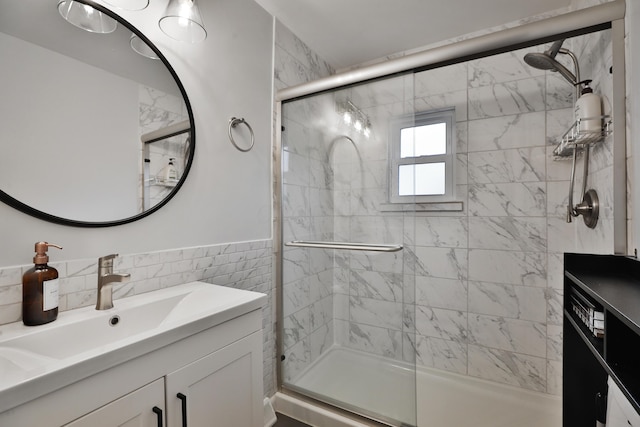 full bathroom featuring a shower stall, tile walls, and vanity