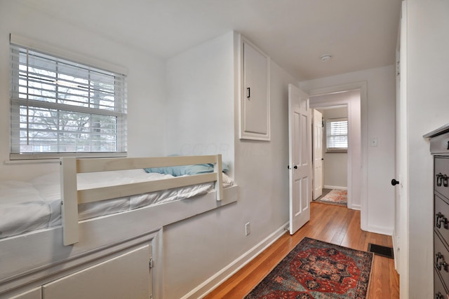 interior space with light wood-type flooring, visible vents, and baseboards