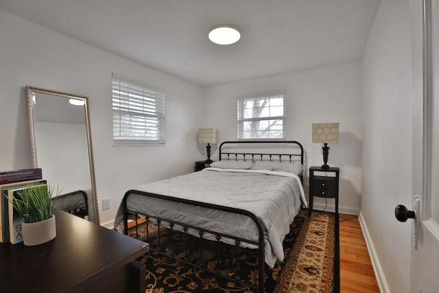 bedroom featuring baseboards and wood finished floors