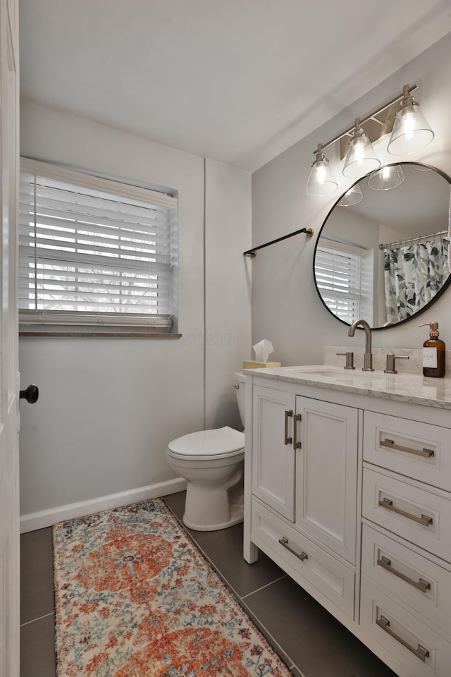 full bathroom featuring tile patterned floors, vanity, toilet, and baseboards