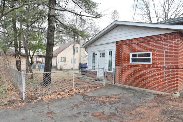 back of house featuring fence private yard and brick siding