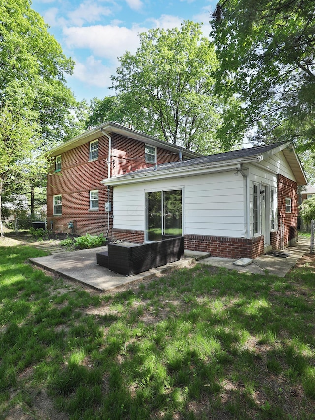 2938 Sherwood Rd, Columbus, OH 43209 - rear view of property featuring a patio area, brick siding, and a yard