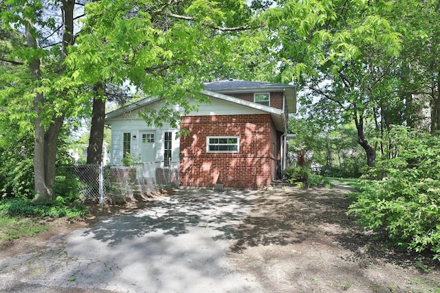2938 Sherwood Rd, Columbus, OH 43209 - view of front of house featuring brick siding, fence, and asphalt driveway