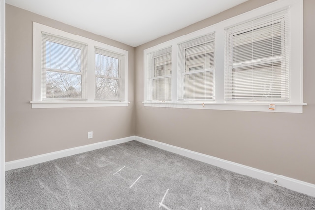 empty room with baseboards and carpet floors