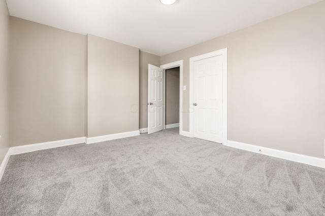 empty room with carpet flooring and baseboards