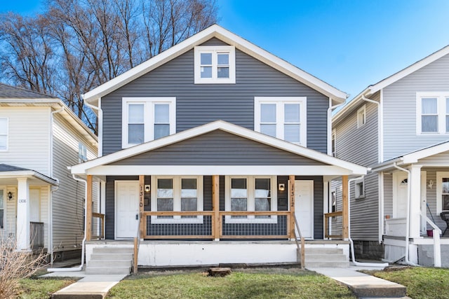 american foursquare style home with covered porch