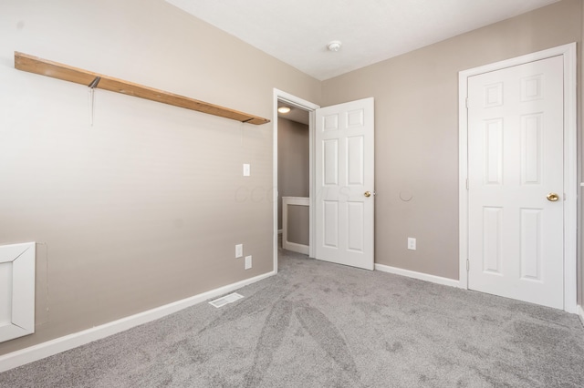 unfurnished bedroom featuring baseboards, visible vents, and carpet floors