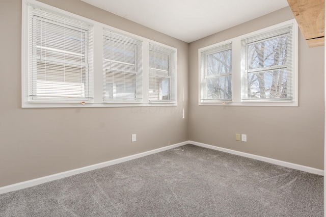 carpeted spare room with baseboards