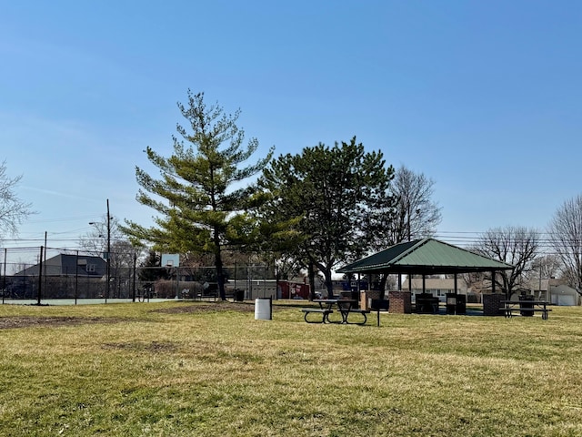 view of home's community with a gazebo, a lawn, a carport, and fence