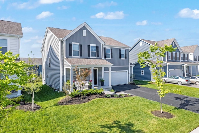 7181 Fenwick St NW, Pickerington, OH 43147 - traditional-style home with asphalt driveway, a front lawn, an attached garage, and roof with shingles