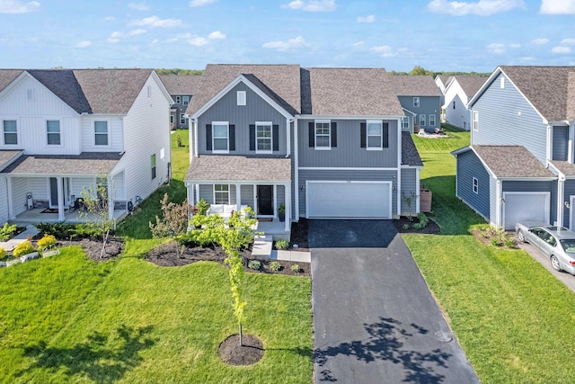 7181 Fenwick St NW, Pickerington, OH 43147 - traditional home featuring asphalt driveway, a residential view, board and batten siding, and a front yard