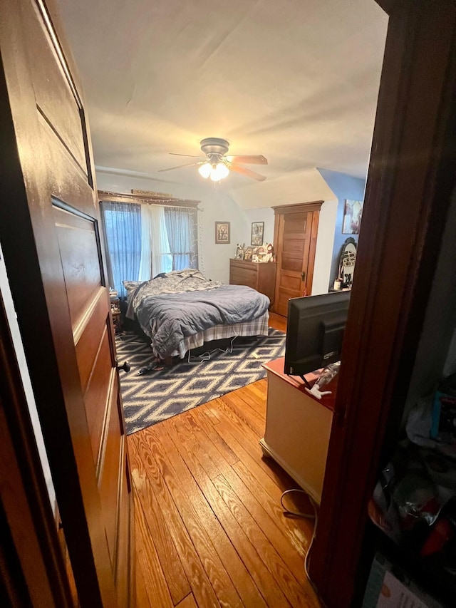 bedroom with hardwood / wood-style flooring and a ceiling fan